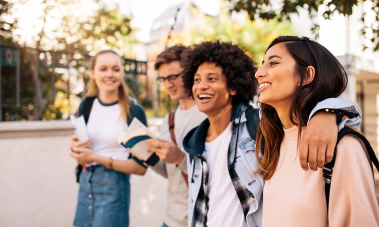 four students walking together at a university