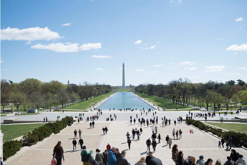 a view of the washington monument with the reflecting pool