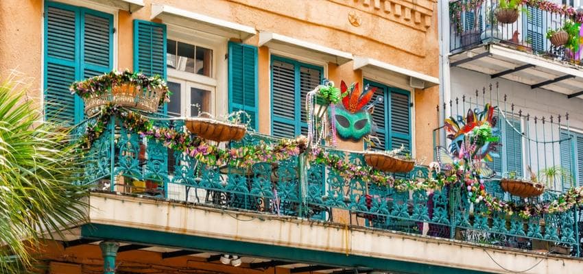 mardi gras masks hanging from balconies in new orleans