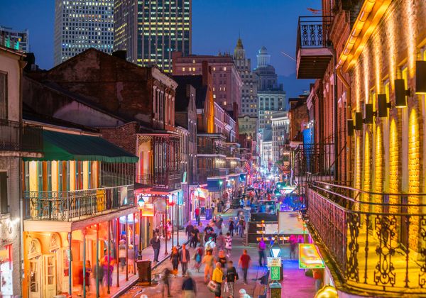 nighttime in the french quarter with people in the streets