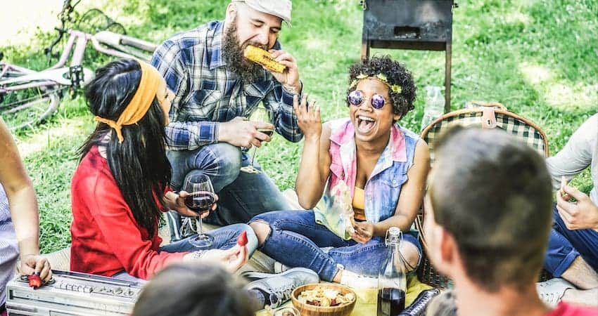 a group of campers share a meal during a group camping trip