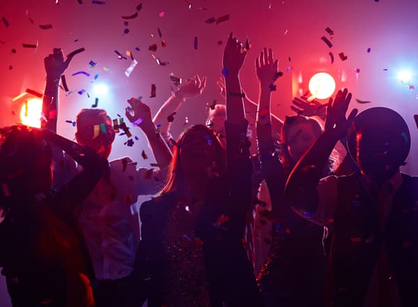 Silhouettes of people dancing in a club