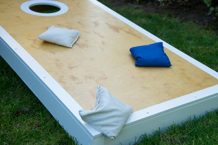 a cornhole game in progress at Phoenix's the yard