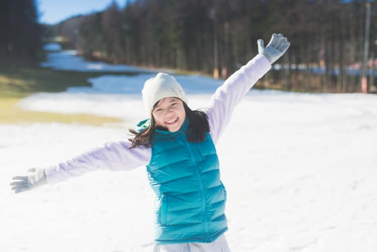 Girl with arms outstretched in snow