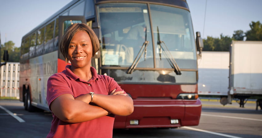 bus driver standing in front of a motorcoach