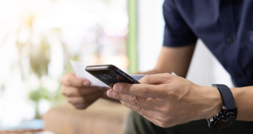 man holding phone and checklist