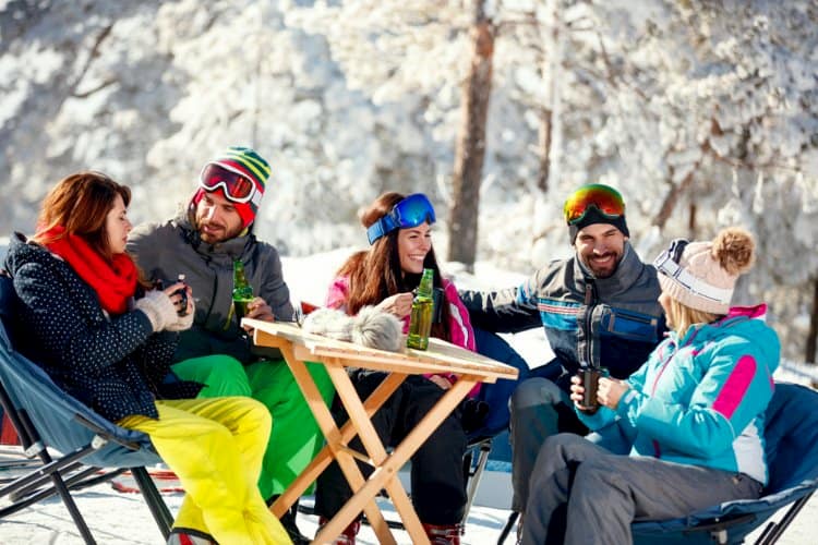 People drinking and laughing after skiing