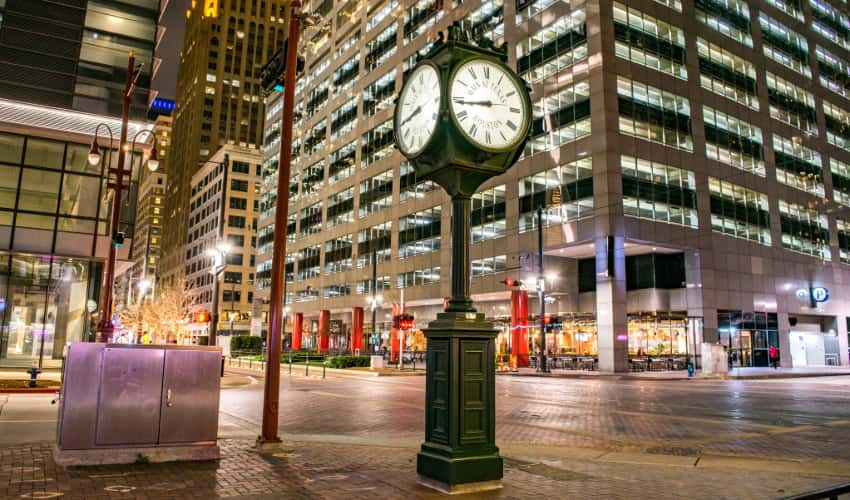 a historic street clock stand on the intersection of Main Street and Texas Street in Houston