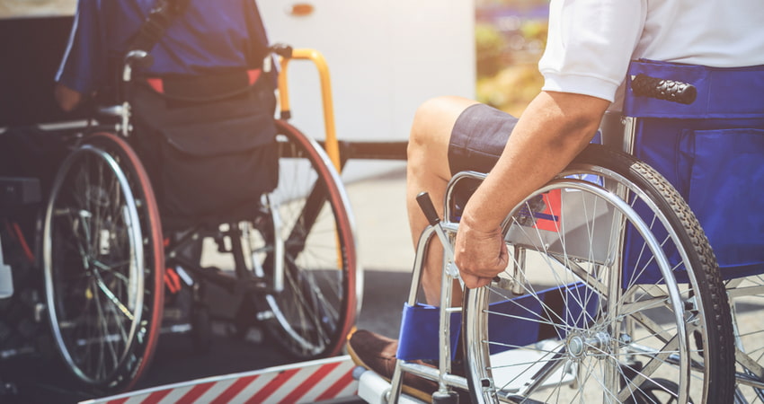 passengers in wheelchairs boarding a charter bus wheelchair lift