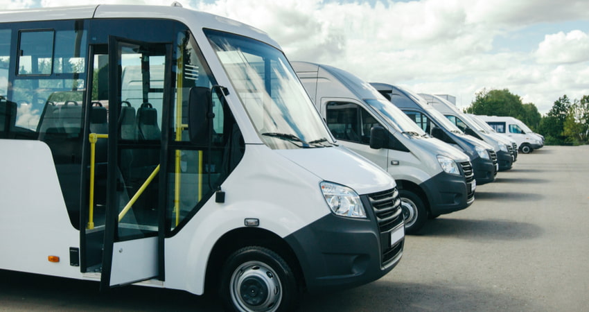 several models of minibus lined up on a parking lot