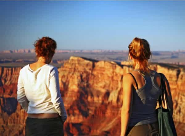 two women hiking at a canyon