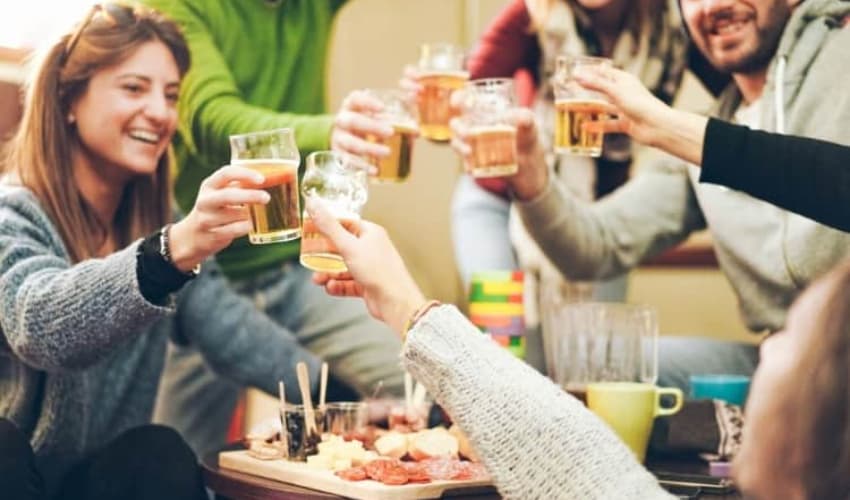 A group of people toasting drinks during apres ski