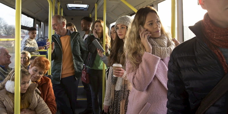 a group of passengers ride along in a new york city public bus