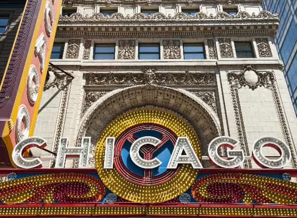 Exterior of a Chicago theatre covered in bulbs and bright signage