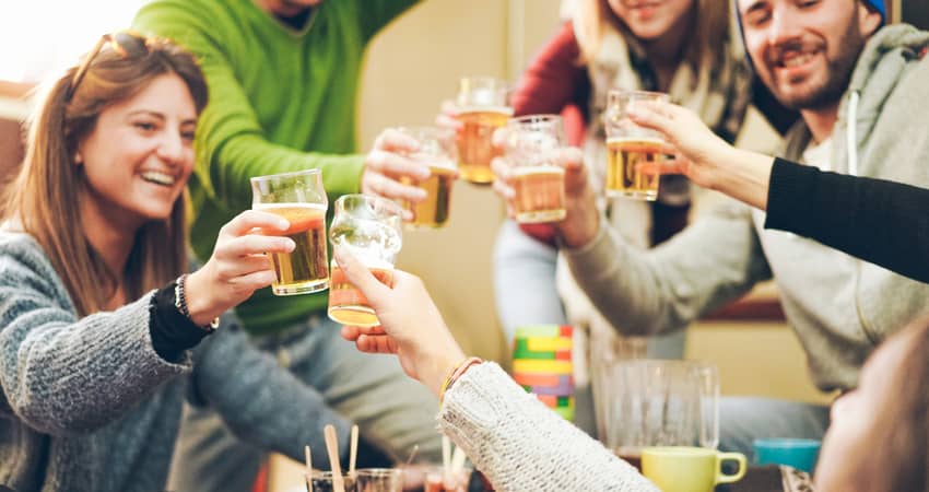 people toasting drinks at a ski resort