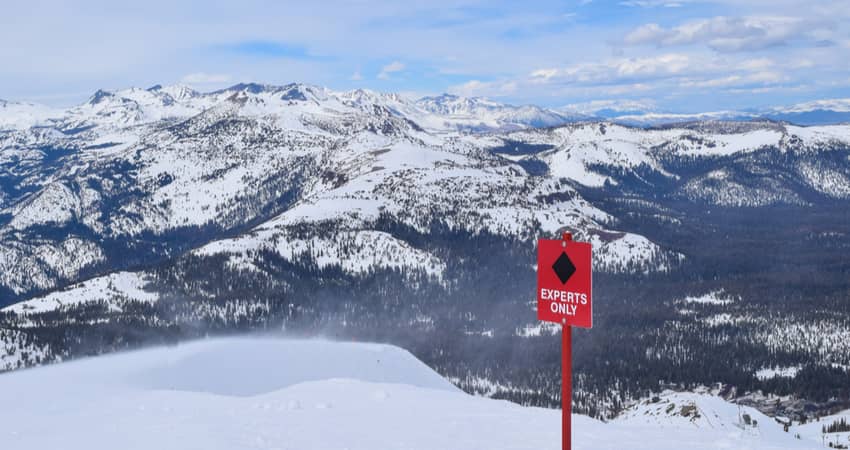 a sign on a ski run indicating it is an expert-only area