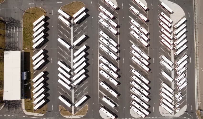 an aerial view of buses in a parking lot