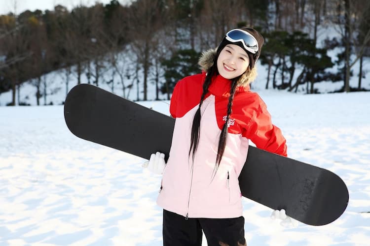 Smiling woman with snowboard