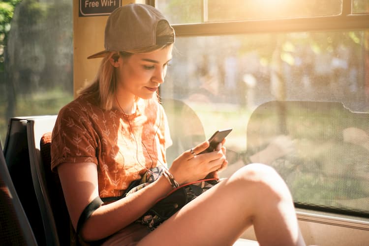 Young woman on phone on bus