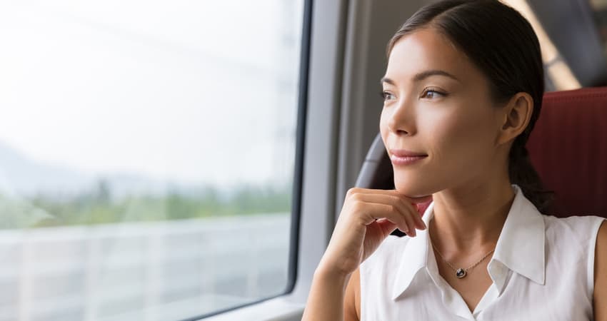 a woman on a shuttle bus looking out the window