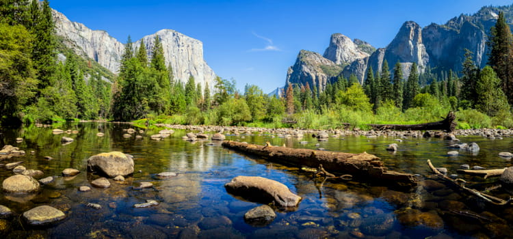 a view of el capitan with a creek in the foreground