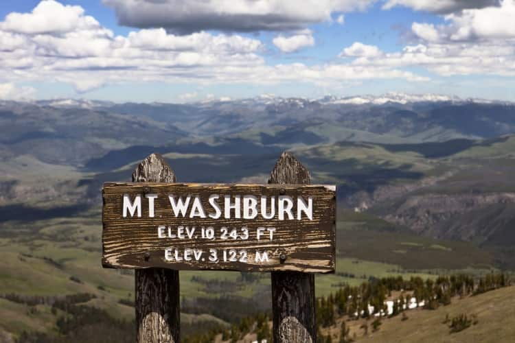 A wooden Mount Washburn sign overlooking Yellowstone National Park