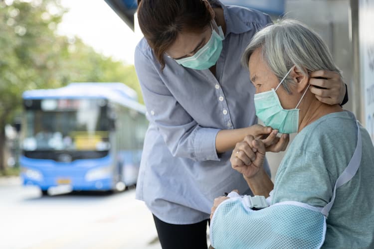 Woman with daughter at bus stop