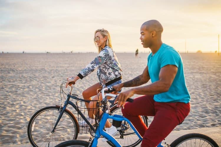 Couple riding bikes at Santa Monica Beach