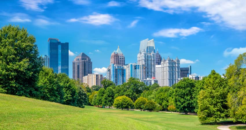 The Atlanta skyline behind trees in Piedmont Park