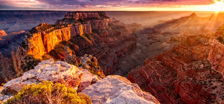 a view of the complex crevasses and rocky hills at sunset