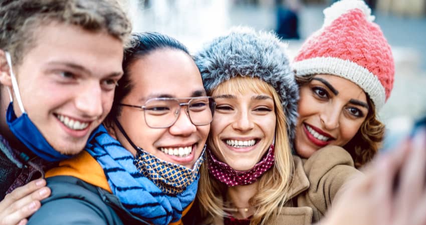 A group of friends smiling in winter gear