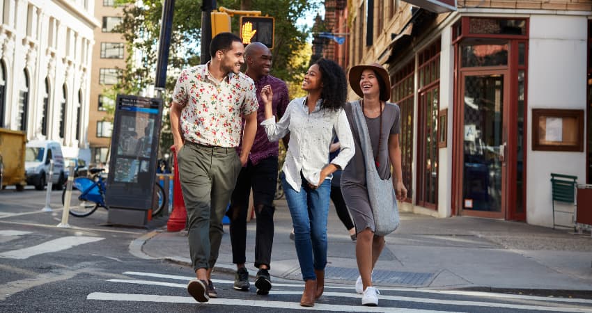 A group of friends cross a city street in NYC