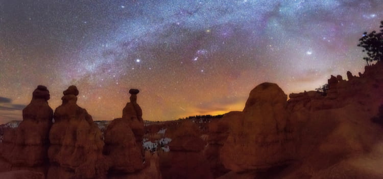 bryce canyon hills with a starry night sky in the background