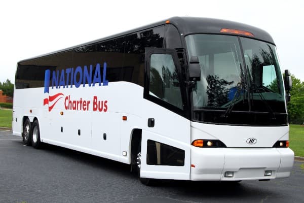 a plain white bus from National Charter Bus with a logo on the side