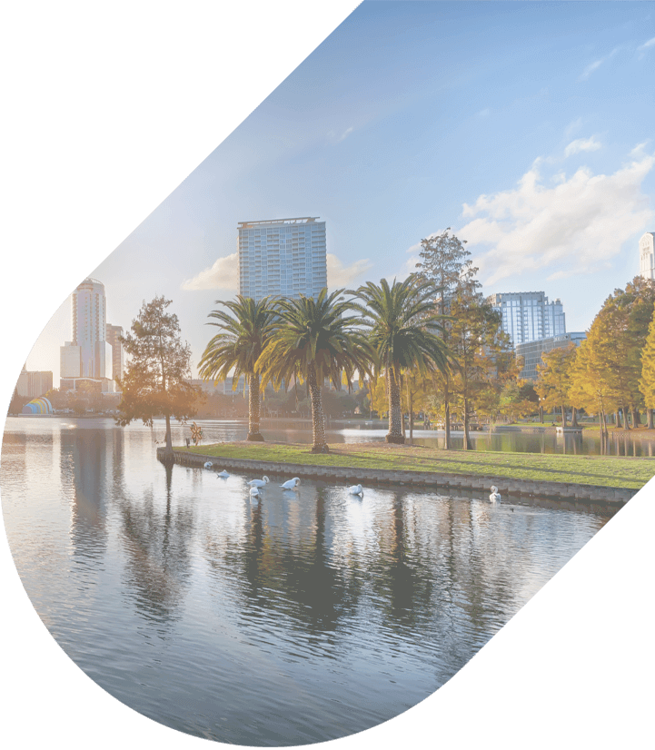 palm trees by the lake with tall Orlando buildings in the background