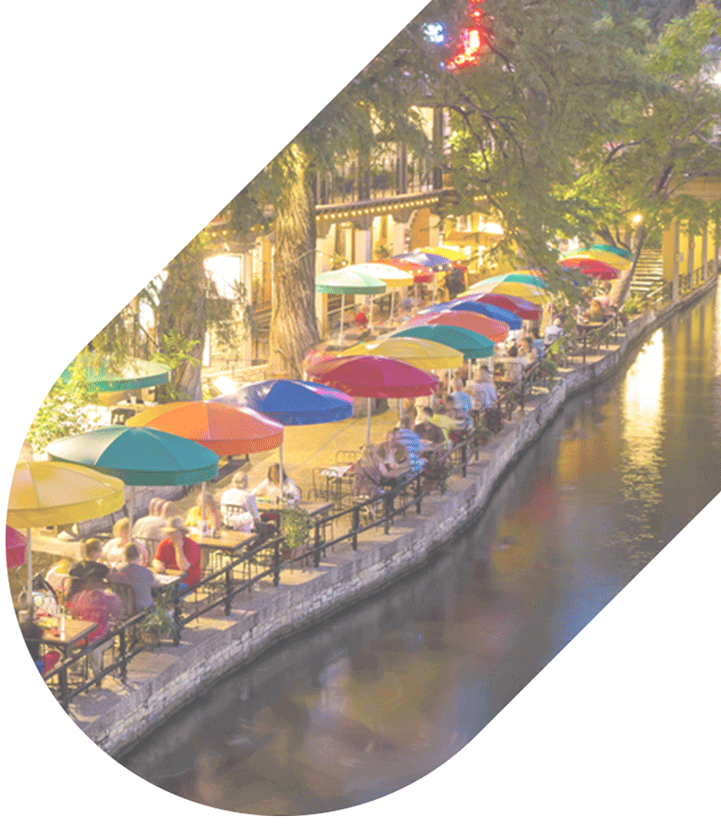 colorful umbrellas along the water on the San Antonio River Walk