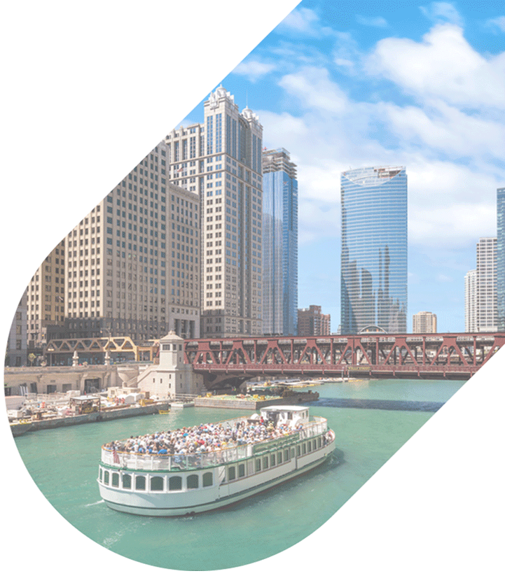 an oblong banner shape containing a boat floating on blue water with a bridge and chicago in the background