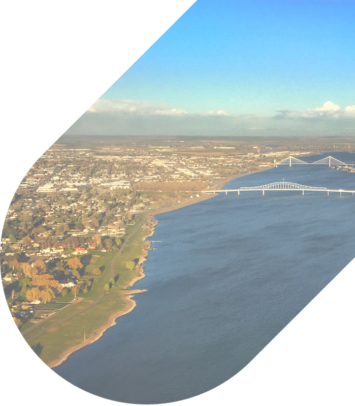 an aerial view of the coast of richland with two large bridges coming into the city