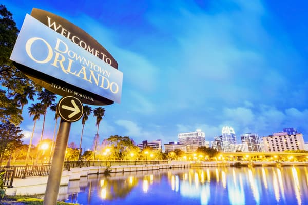 a "welcome to downtown orlando" sign near lake eola park