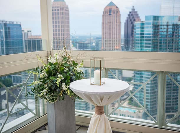 Wedding decor in front of a gallery window that looks over the Atlanta skyline