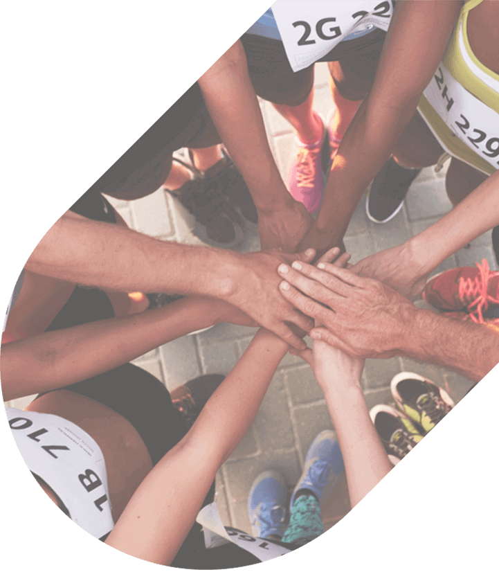 a closeup of marathon runners placing hands in a circle