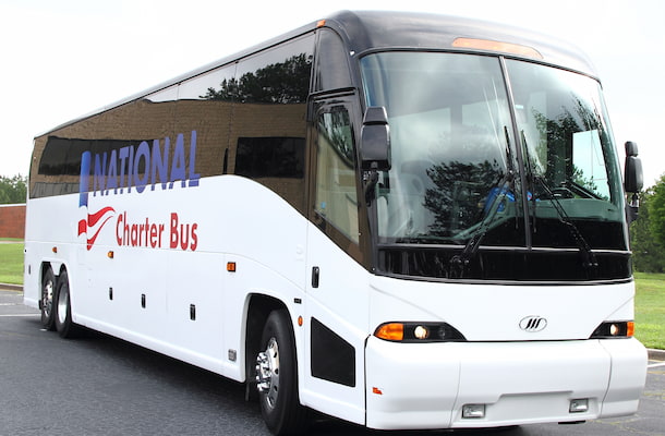 a plain white charter bus with a blue and red "national charter bus" logo on the side