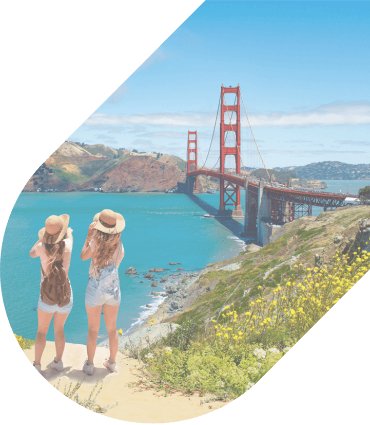 two friends stand over the bay looking towards the Golden Gate Bridge