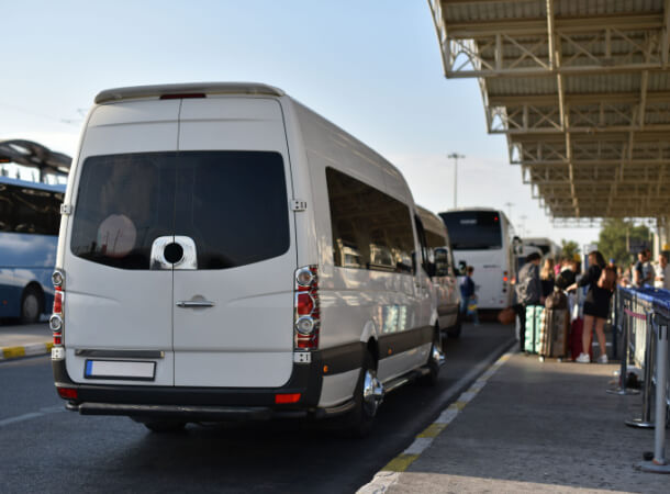 a minibus shuttle picking up guests at the airport