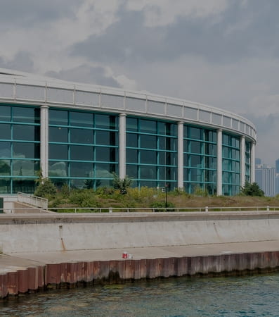 The external green glass facade of the Shedd Aquarium