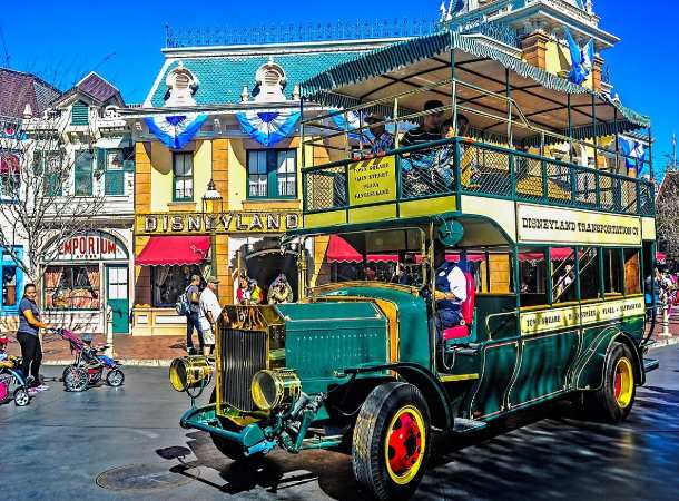 A colorful shuttle bus drives down Main Street in Disneyland in Los Angeles