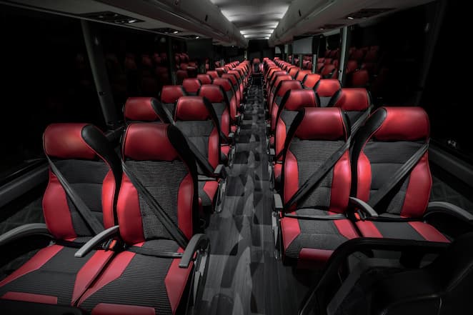 Interior of an X3-45 bus with black and red seats