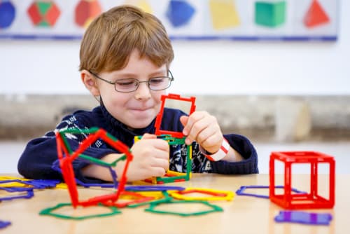Child building with colorful pieces of plastic