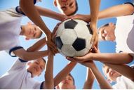 young athletes in a circle with a soccer ball