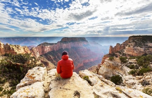 Man sitting in Grand Canyon